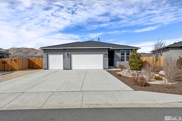 single story home with a garage and a mountain view