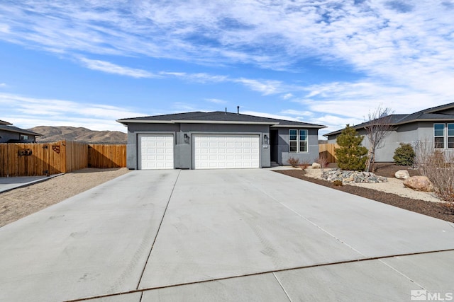 ranch-style house featuring a garage and a mountain view