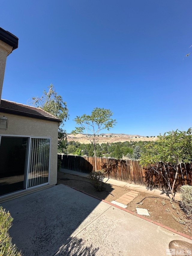 view of yard featuring fence and a patio area