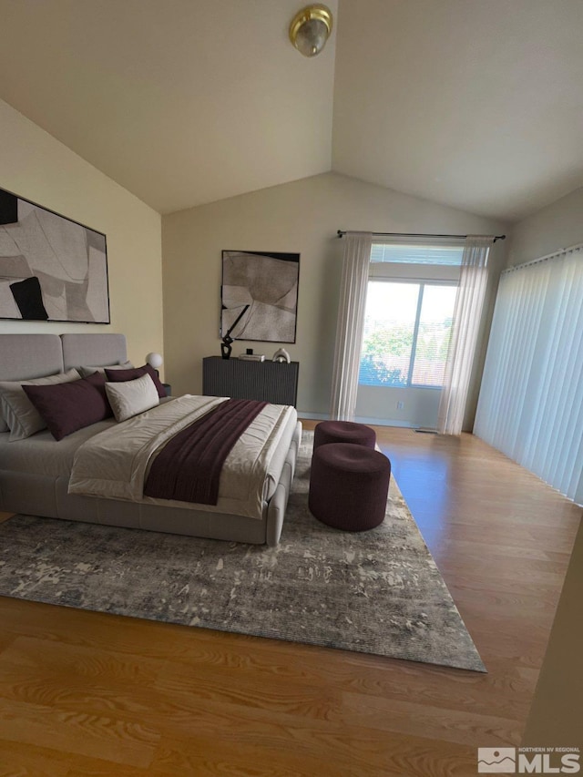 bedroom featuring lofted ceiling and wood finished floors