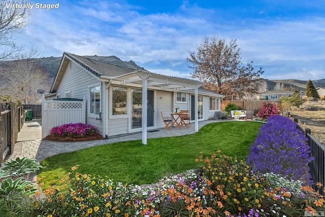 back of house featuring a yard, a pergola, and a patio