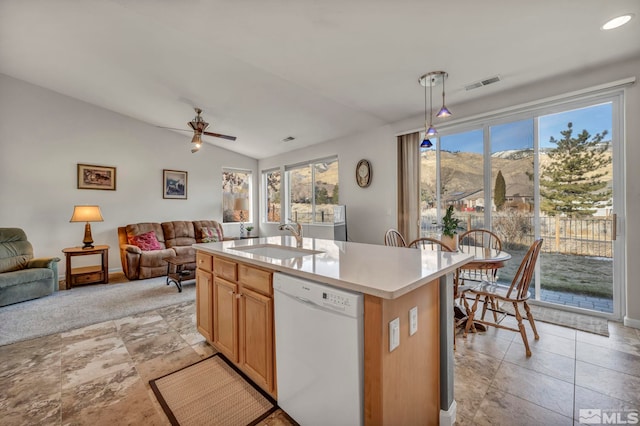 kitchen with pendant lighting, sink, dishwasher, plenty of natural light, and a center island with sink