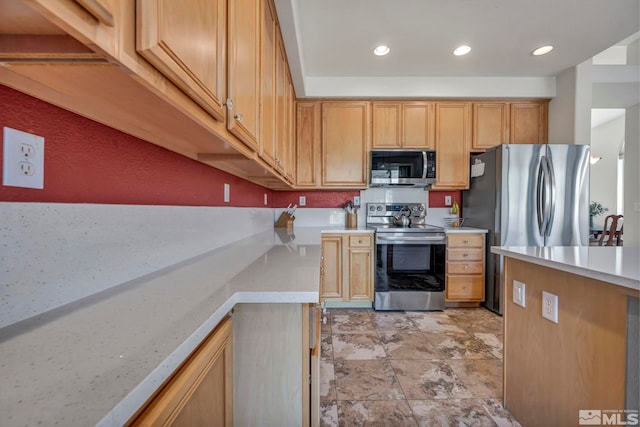 kitchen with stainless steel appliances and light brown cabinetry