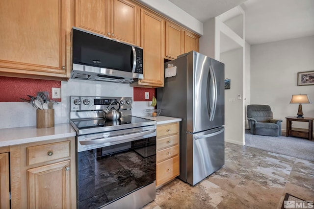 kitchen featuring stainless steel appliances and light brown cabinets