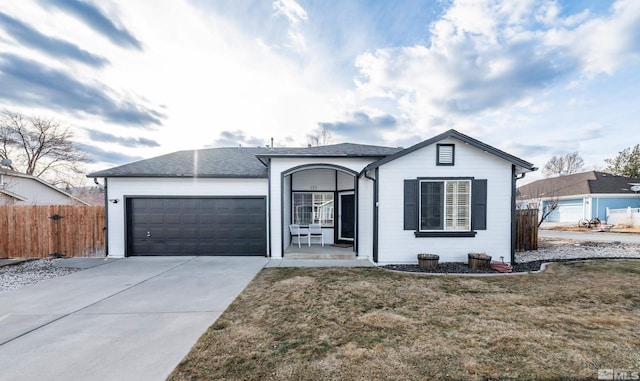 ranch-style house featuring a garage and a front lawn