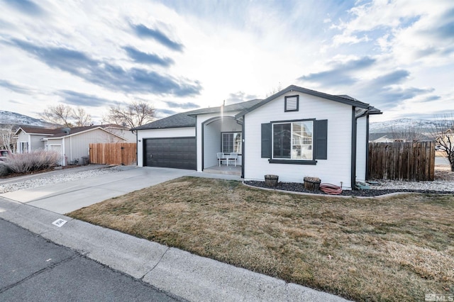 ranch-style house with a garage and a front yard