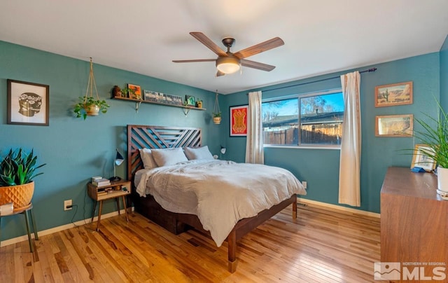 bedroom with light hardwood / wood-style floors and ceiling fan