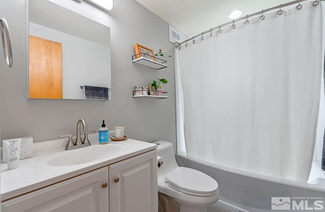 full bathroom featuring vanity, shower / tub combo, and toilet