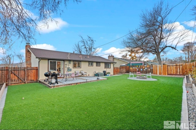 rear view of property with a patio, a yard, and cooling unit