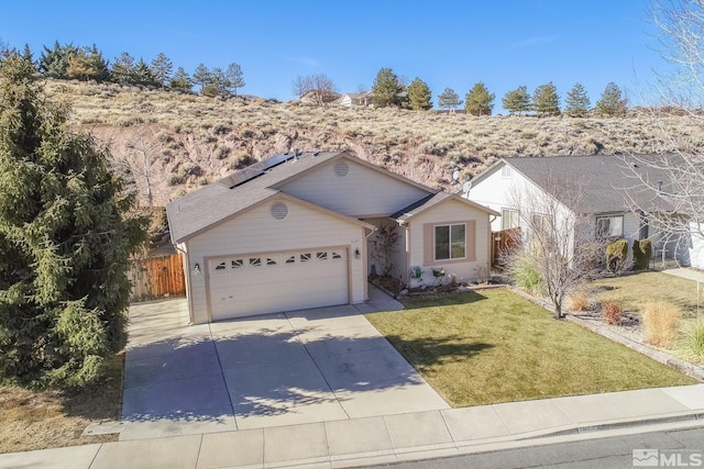 ranch-style home featuring a garage, a front lawn, and solar panels