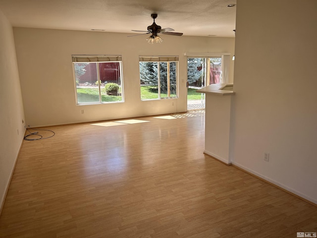 unfurnished room featuring ceiling fan and light hardwood / wood-style flooring