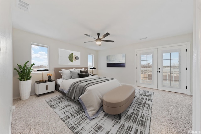 bedroom featuring multiple windows, access to outside, ceiling fan, and french doors