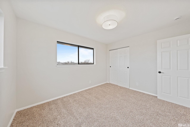 unfurnished bedroom with carpet and a closet