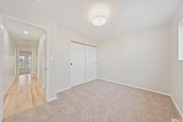 unfurnished bedroom with carpet floors and a closet