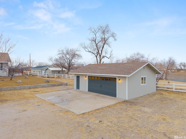 view of home's exterior with a garage, an outdoor structure, and a lawn