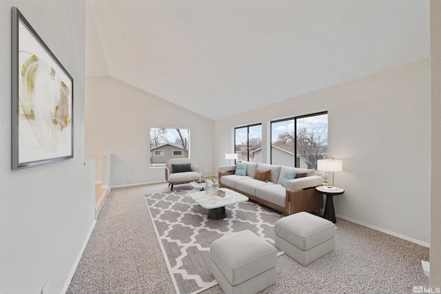 carpeted living room with vaulted ceiling