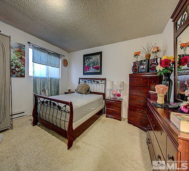 bedroom with light carpet, a baseboard heating unit, and a textured ceiling