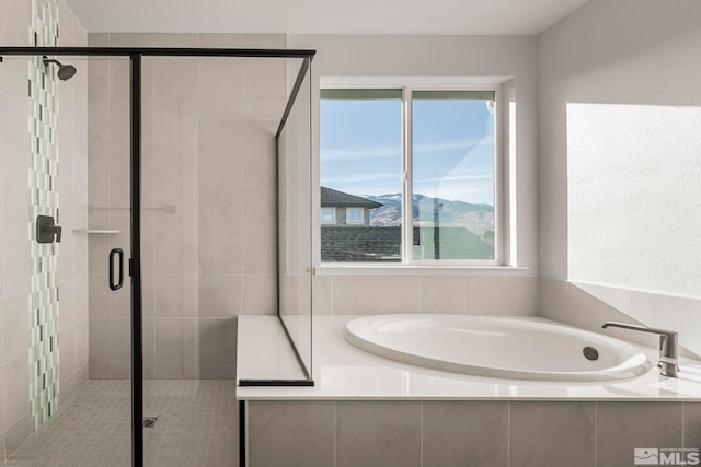 bathroom with independent shower and bath and a mountain view