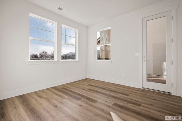 unfurnished room featuring hardwood / wood-style floors