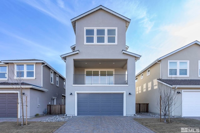 view of front of home featuring a balcony and a garage