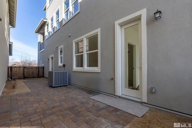 rear view of house featuring central AC unit and a patio area