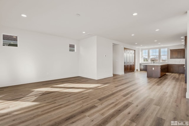 unfurnished living room with light hardwood / wood-style floors