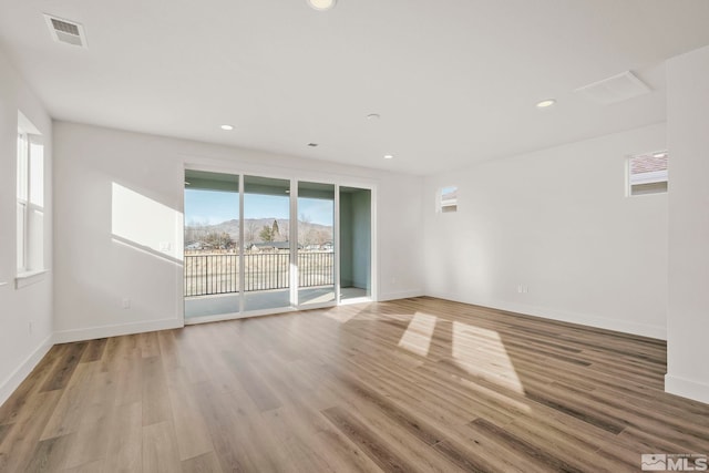 unfurnished room featuring light hardwood / wood-style floors