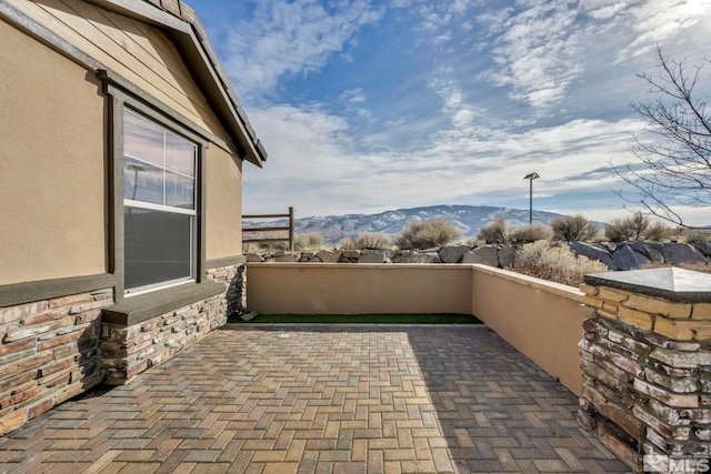 view of patio / terrace featuring a mountain view