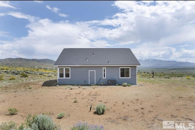 rear view of property with a mountain view and central air condition unit