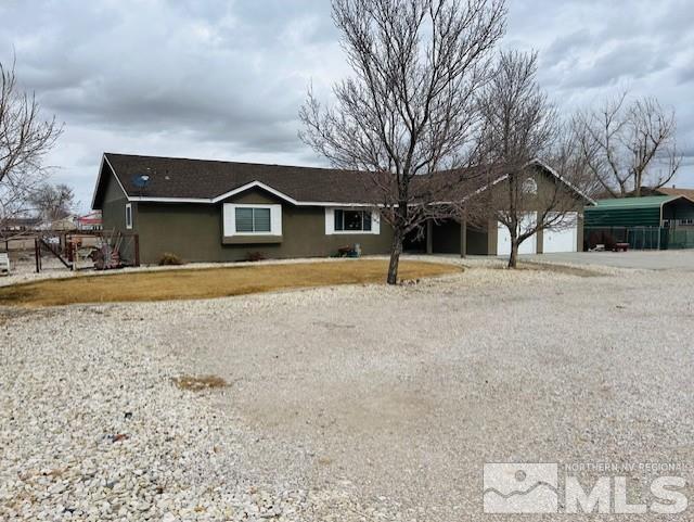 ranch-style home with a carport and a garage