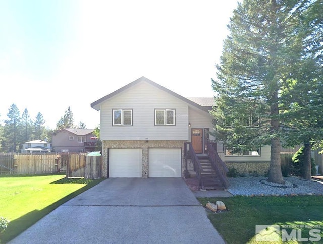 view of front of house with a garage and a front lawn