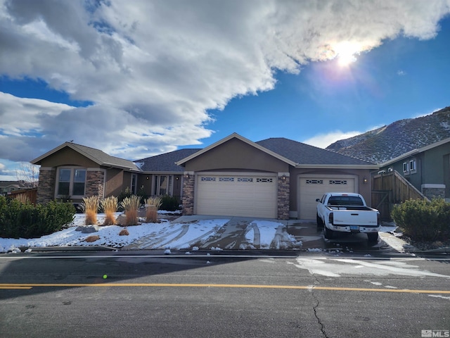 ranch-style home featuring a garage and a mountain view