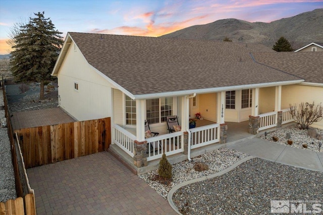 view of front of home featuring a porch and a mountain view