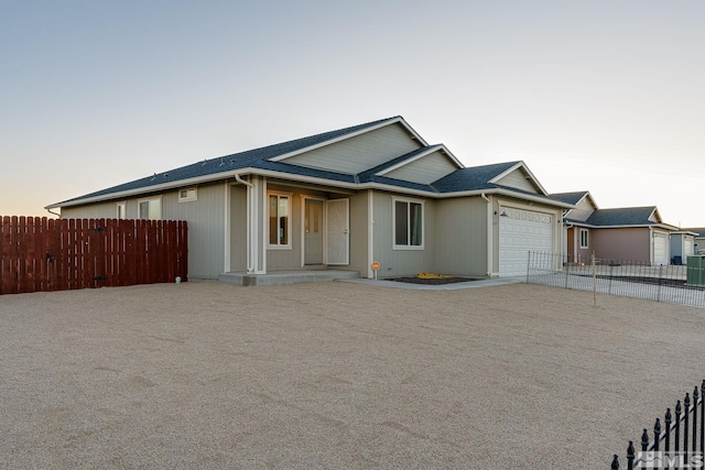 ranch-style house with central AC unit and a garage