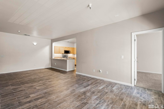 unfurnished living room with dark hardwood / wood-style flooring