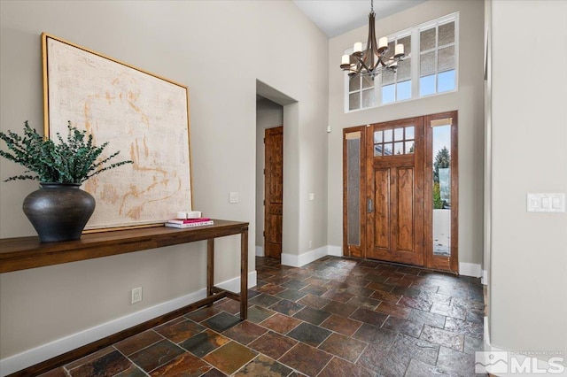 foyer with a high ceiling and an inviting chandelier