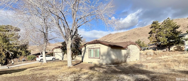 view of property exterior with a mountain view