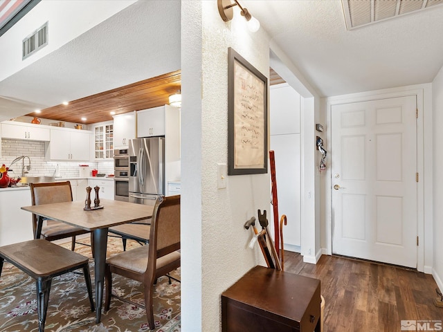 dining area featuring dark hardwood / wood-style floors and a textured ceiling