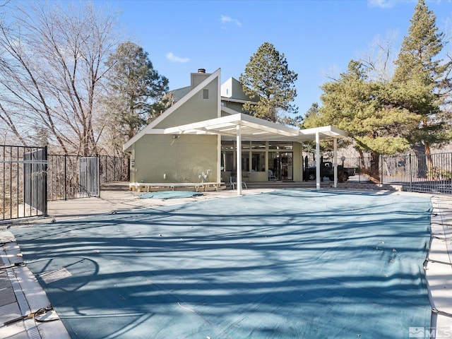 exterior space featuring a patio, a covered pool, and a pergola