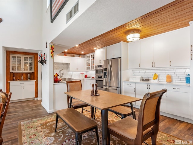 dining room with dark wood-type flooring, sink, and wood ceiling