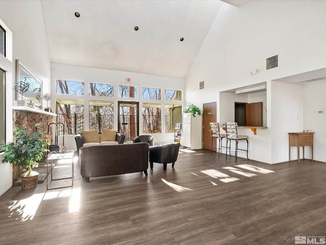 living room with dark hardwood / wood-style floors and high vaulted ceiling