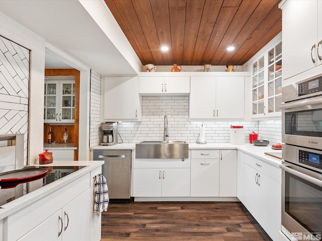 kitchen featuring sink, appliances with stainless steel finishes, tasteful backsplash, white cabinets, and wooden ceiling