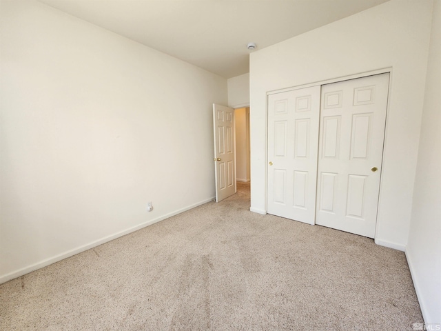 unfurnished bedroom with a closet and carpet flooring