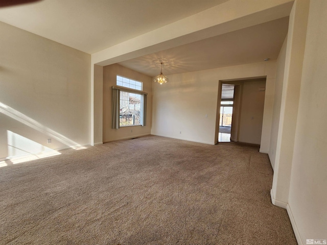 empty room featuring an inviting chandelier and carpet