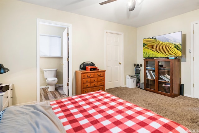 bedroom with light carpet, ensuite bath, and ceiling fan