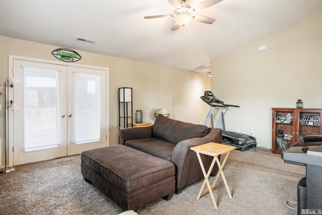 carpeted living room with french doors and ceiling fan