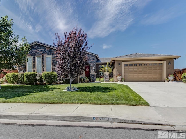 view of front of property featuring a garage and a front lawn