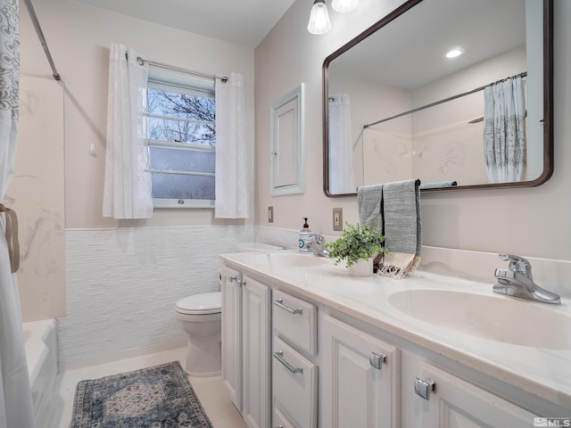 full bathroom with tile patterned floors, toilet, bathing tub / shower combination, tile walls, and vanity