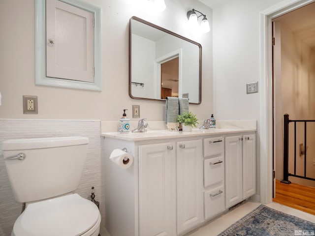 bathroom featuring vanity, tile patterned flooring, and toilet