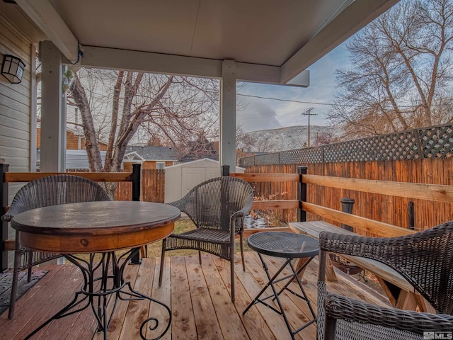 wooden terrace featuring a storage unit